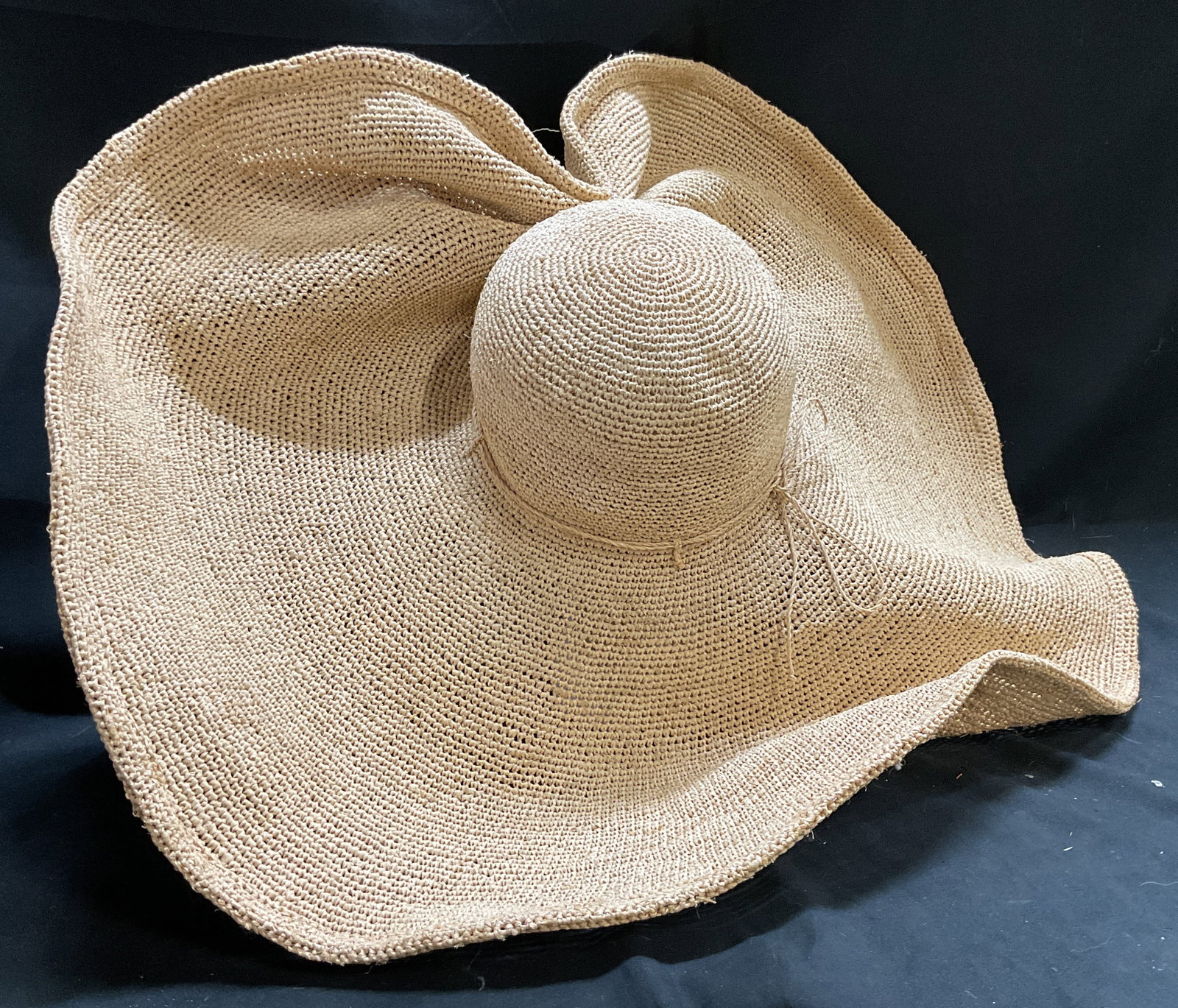 NWT Kokin Ultra-Wide-Brim Crocheted Straw Sun Hat: New with Tags Kokin Ultra-Wide-Brim Crocheted Straw Sun Hat. Asymmetrical floppy brim. Tie accent. Bohemian Style. New York. Condition consistent with age and exposure. Measures app 7.5in Head Diam x