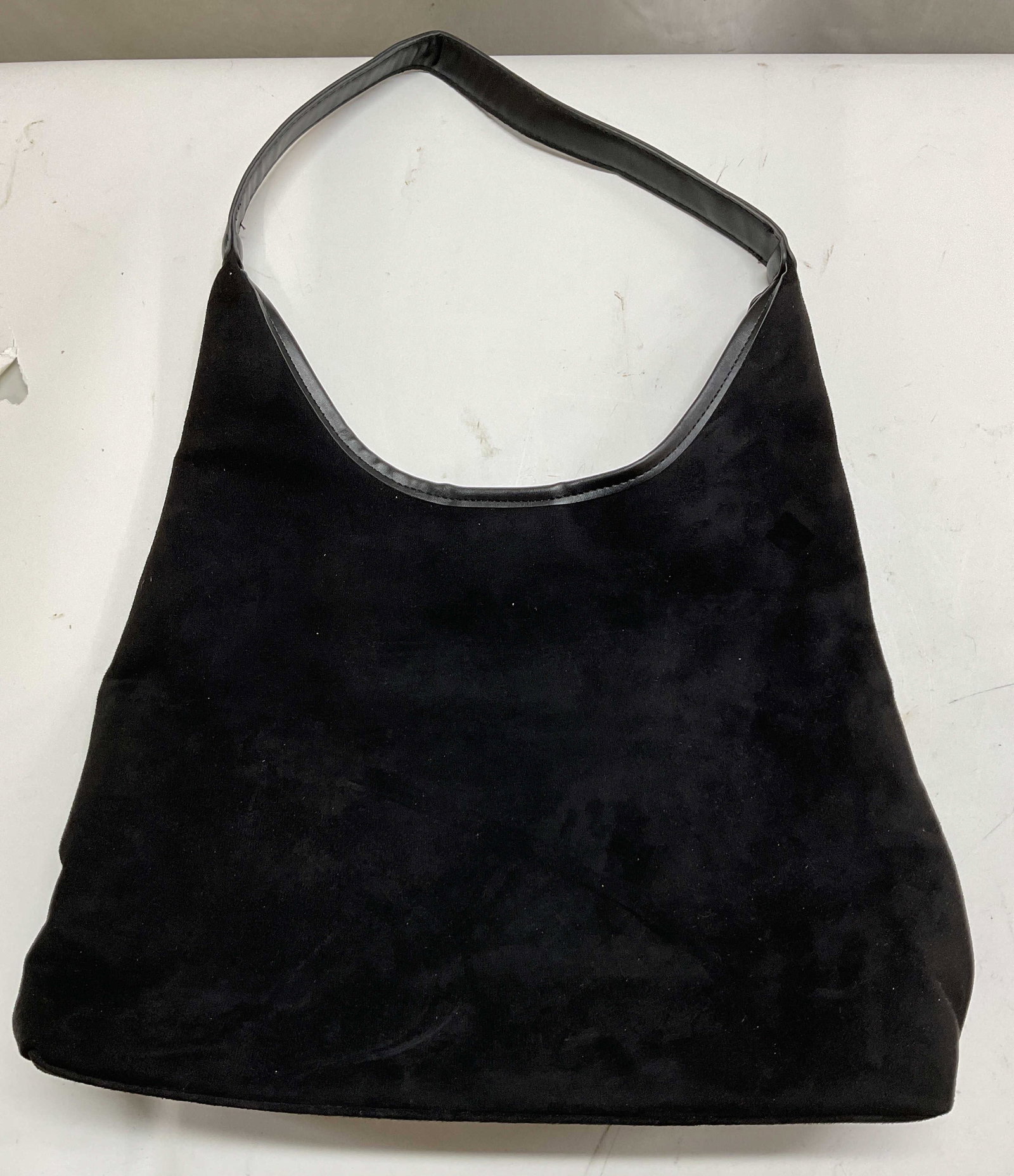 Vintage Black Shoulder Bag: Suede look and feel. Vintage black shoulder bag. Attached strap. Interior compartments. Magnetic button closure. Measures approx 11.5 x 15 inches. Surface wear consistent with exposure. Bag, shoulder