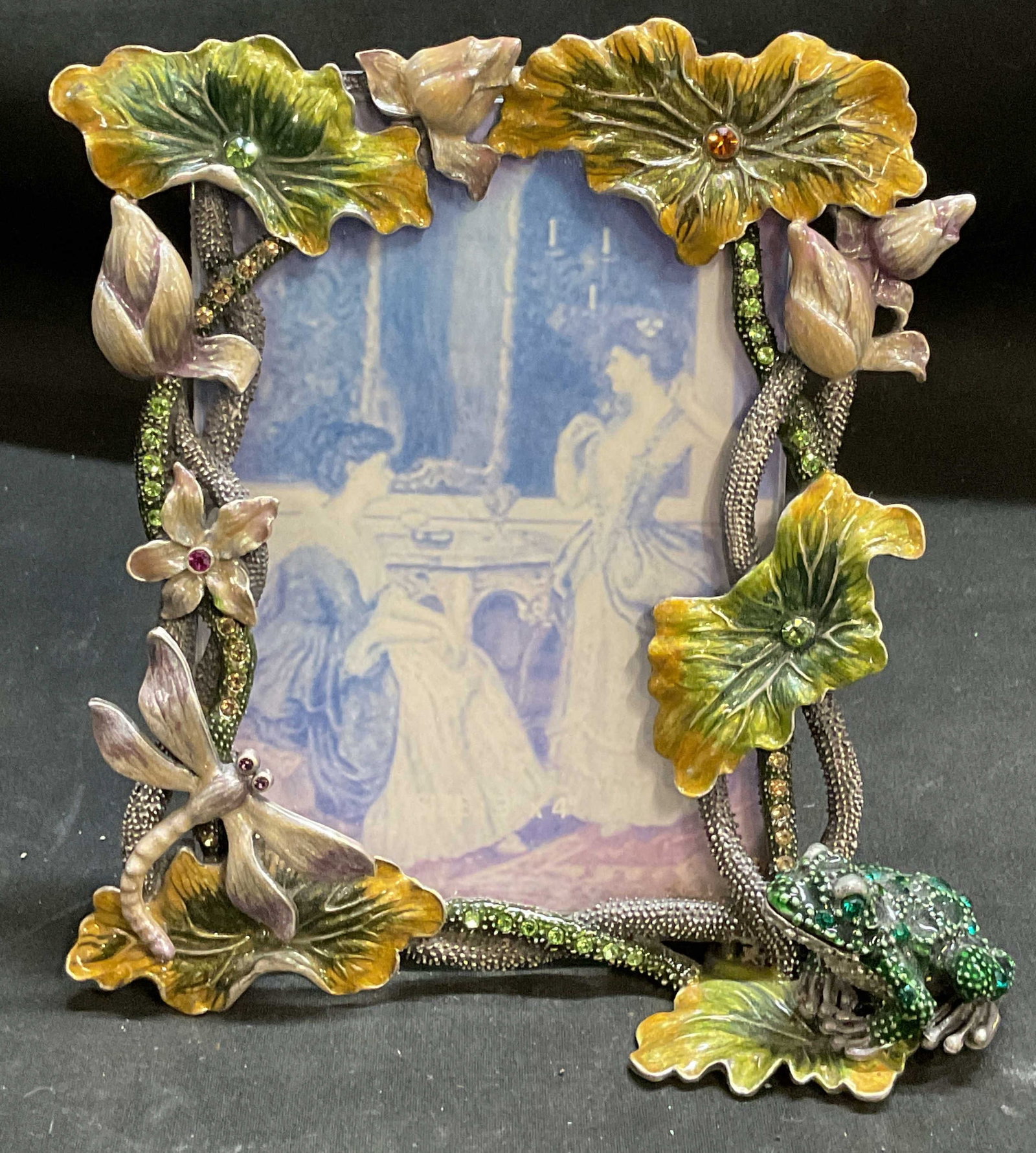 Vtg 04 Enameled Rhinestone Pond Theme Frame: Vintage 2004 Enameled Pond Theme Picture Frame. Features green bullfrog, dragonfly, lily pads, and lotus leaves. Rhinestone accents. Condition consistent with age and exposure. Measures app 5in H x