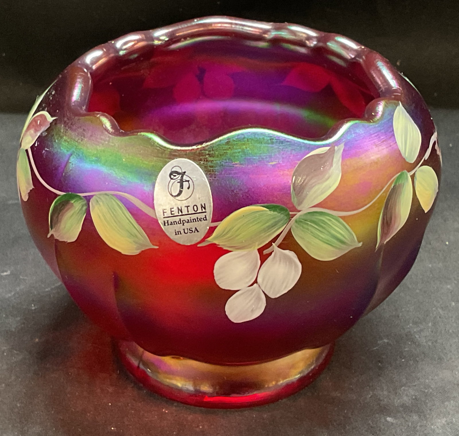 Vtg Sgnd Caplinger Fenton Trailing Wisteria Bowl: Vintage Circa 1990s Signed Fenton Trailing Wisteria Ruby Amberina Stretch Carnival Glass Rose Bowl. Multi-Colored metallic iridescence. Hand-Painted white floral design by M.Caplinger. Some