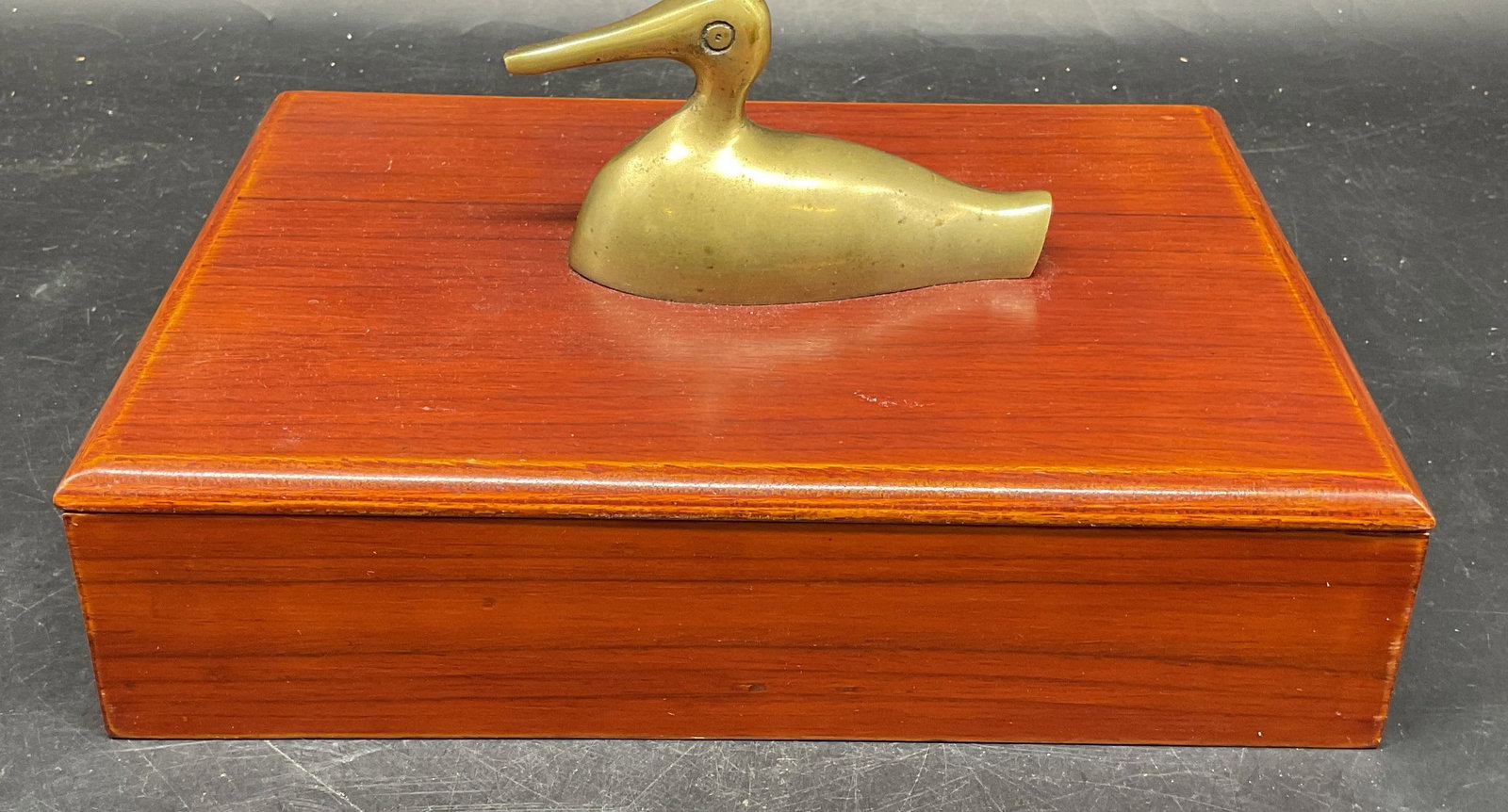 Wood Brass Duck Figural Dresser Jewelry Box: Wood dresser or jewelry box with brass duck shaped handle. Felt lined interior with compartments. Measures approx. 9 x 6.5 x 4.5 inches. Some scratching. Duck jewelry box, duck box, dresser box,