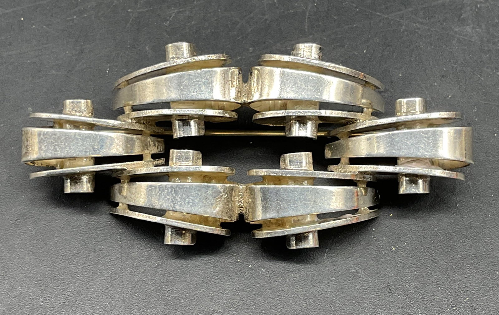 Vintage Monet Sterling Silver Ribbon Brooch: Vintage Monet sterling silver modernist ribbon brooch. Marked sterling. Measures approx. 2.5 x 1.25 inches. Total weight .77 Troy ounces. Some scratching. Jewelry, estate jewelry, fine jewelry,