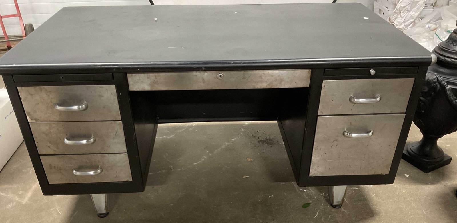 C 1960,s Steel Case Office desk: Industrial style , sturdy with strong lines, mid century vintage metal tanker desk, two tone aesthetic with a dark painted frame and brushed steel drawers and feet, signature curved metal handles and