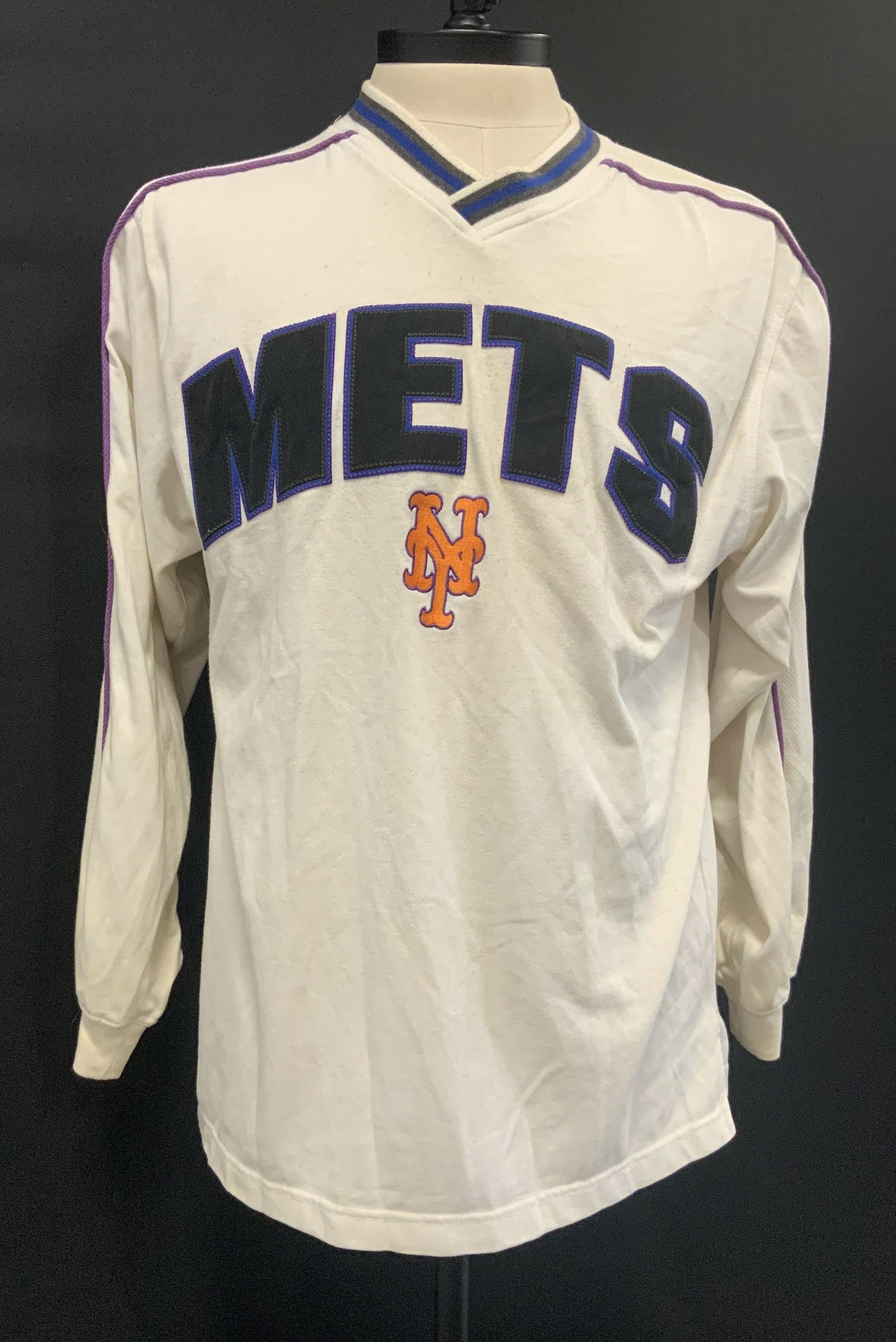 Vntg LEE SPORT NY Mets long sleeve shirt,1990s: Vintage LEE SPORT NY Mets long sleeve shirt. Made in the 1990s from a cotton polyester blend in size medium. Features a v neck collar with thick striped ribbing. The sleeves have distinct mesh and pur