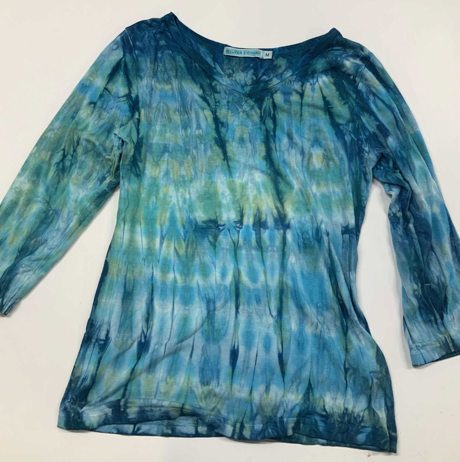 SILVER CHARM blue and green tie dye shirt, USA: SILVER CHARM blue and green tie dye shirt. Made in the USA from a rayon spandex blend in size medium. It features a scoop neckline and 3/4 length sleeves. The design uses a vertical accordion stripe t