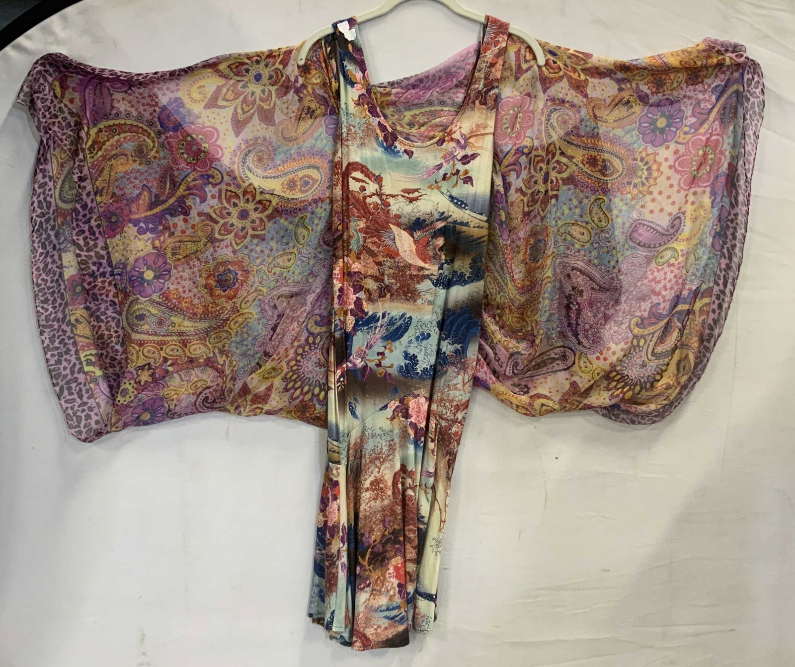 2 piece colorful printed midi dress and shawl: 2 piece colorful printed midi dress and shawl. The base is a midi drop waist style dress held up by standard tank top straps. The second piece is connected by a single stitch at the top of the shoulde
