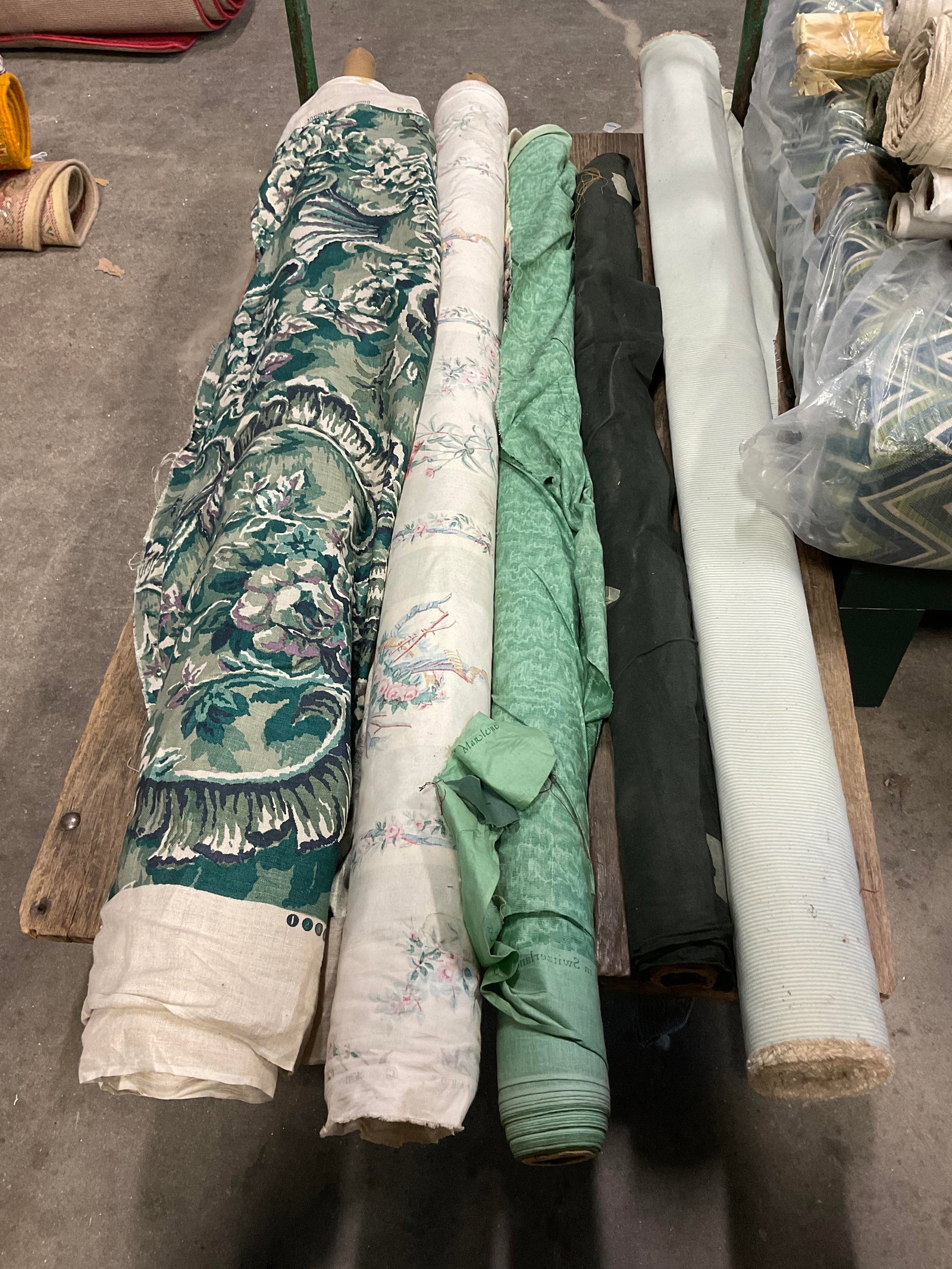 Lt 5 Green Bolts of Fabric: Lt 5 Green Bolts of Fabric. Mixed Materials. Linen, Cotton, and More. Solid, Striped, and Floral Patterns. Not Measured, Unrolled, or Inspected. Sold As Is. Part of Large Collection of NYC Interior
