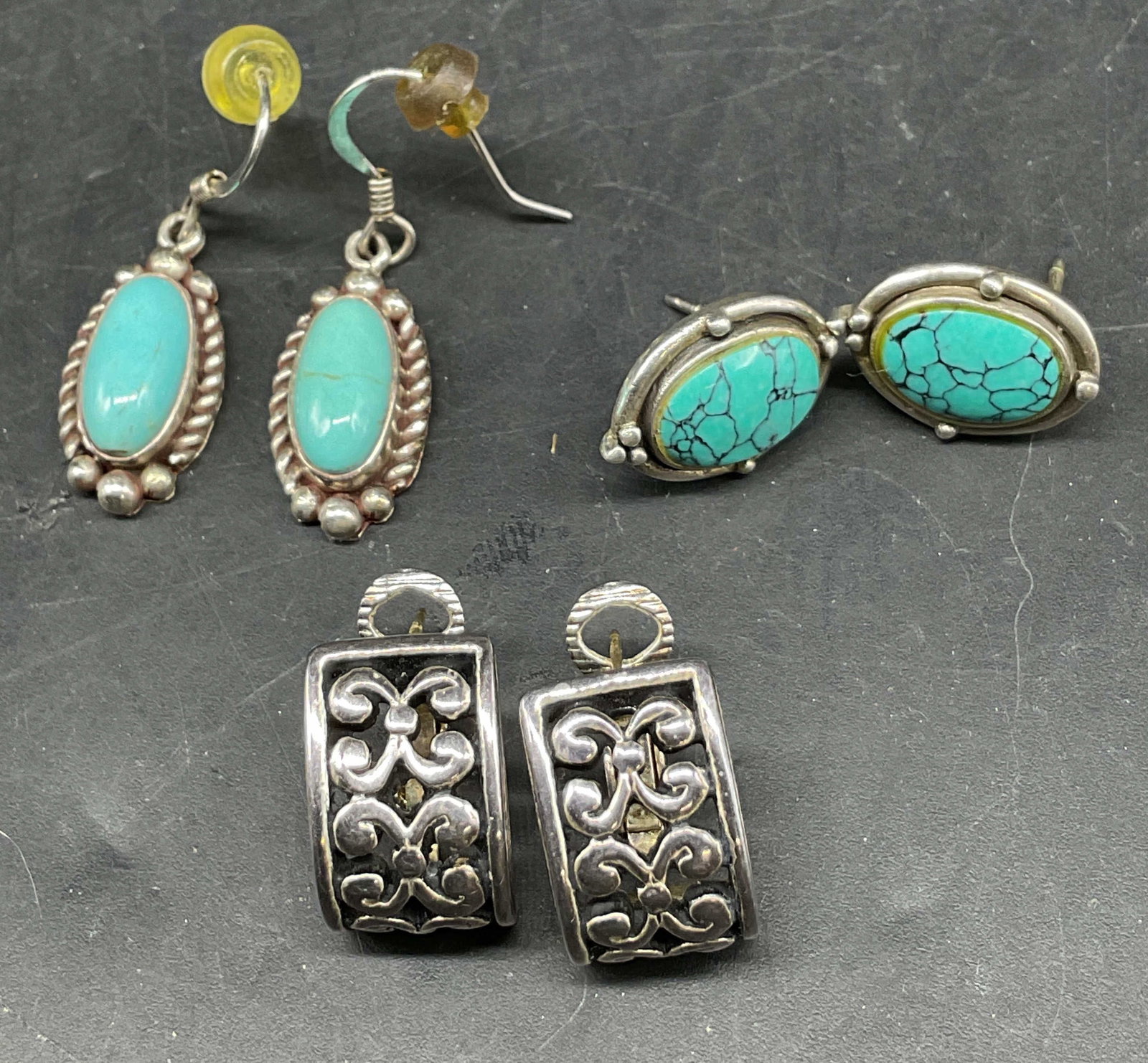 Lot 3 Vtg Assorted Earrings Sterling Silver+: Lot of 3 vintage assorted earrings. Silver toned earrings with scroll motif, half hoop. Sterling silver earrings with turquoise and textured border, marked Nabiho Sterling, oval shaped. Sterling