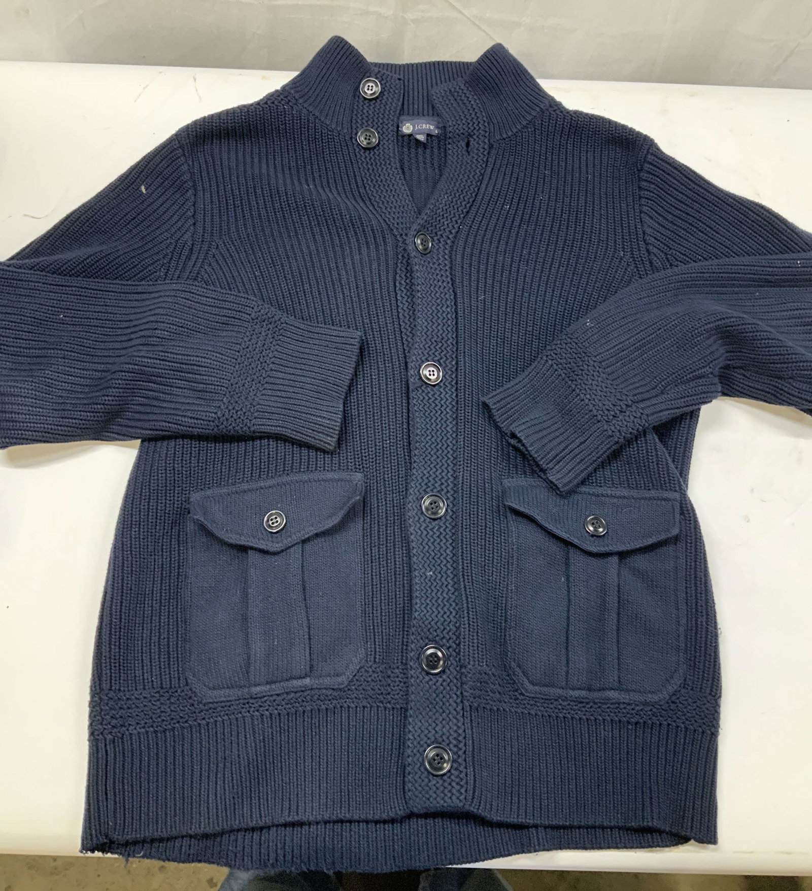 J.Crew navy blue button cardigan.: J.Crew navy blue button cardigan. Made if 100% cotton in size large. Crafted using a heavy vertical ribbed knit. The cuffs placket, collar and hem are finished with a zig zag stitch then tight