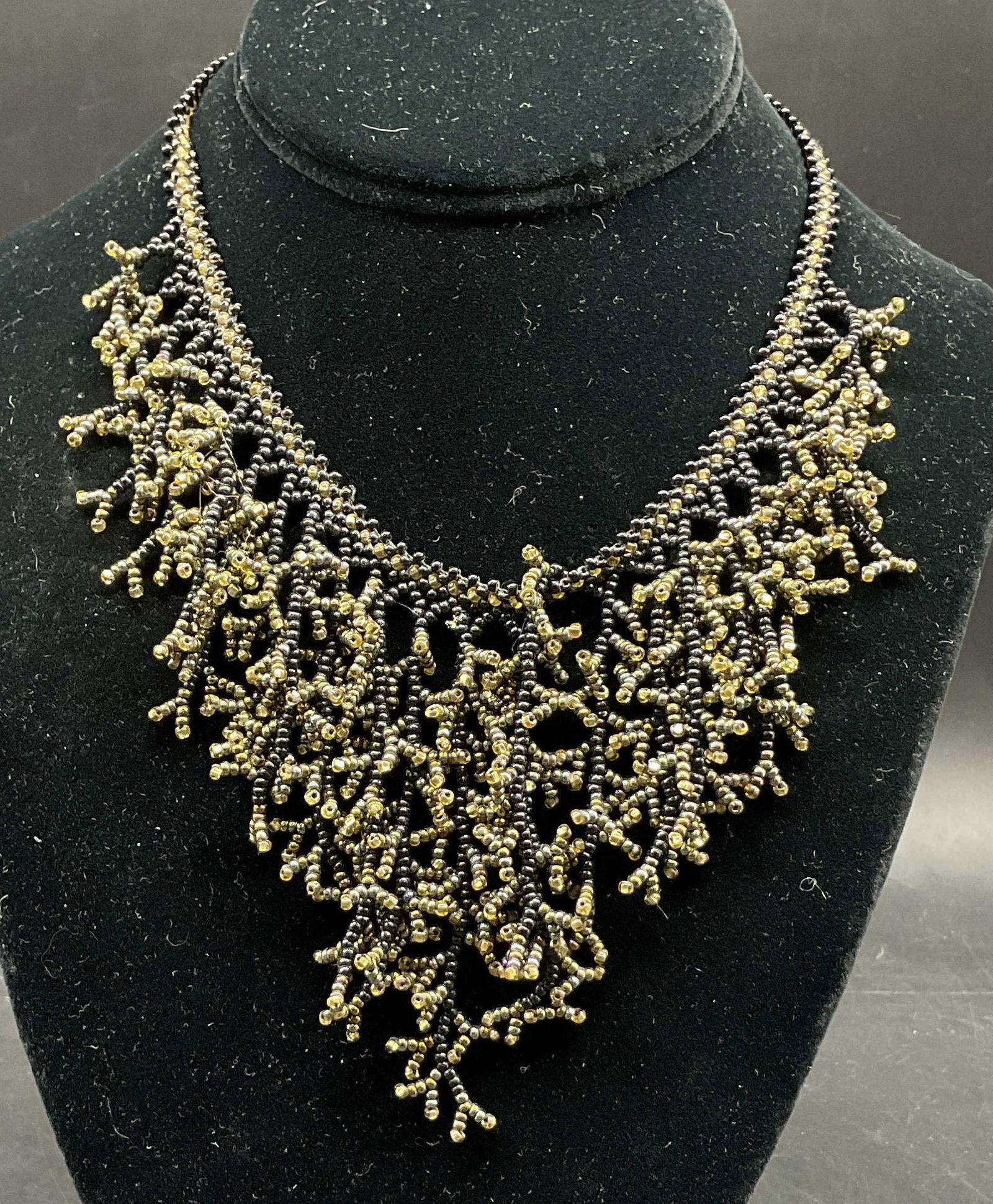 Vtg Black & Yellow Seed Beaded Fringe Bib Necklace: Vintage black and yellow seed beaded fringe bib necklace. Combination of black and yellow seed beads in a fringed design. Measures approx 11 inches drop length. Scratching. Jewelry, necklace, bib
