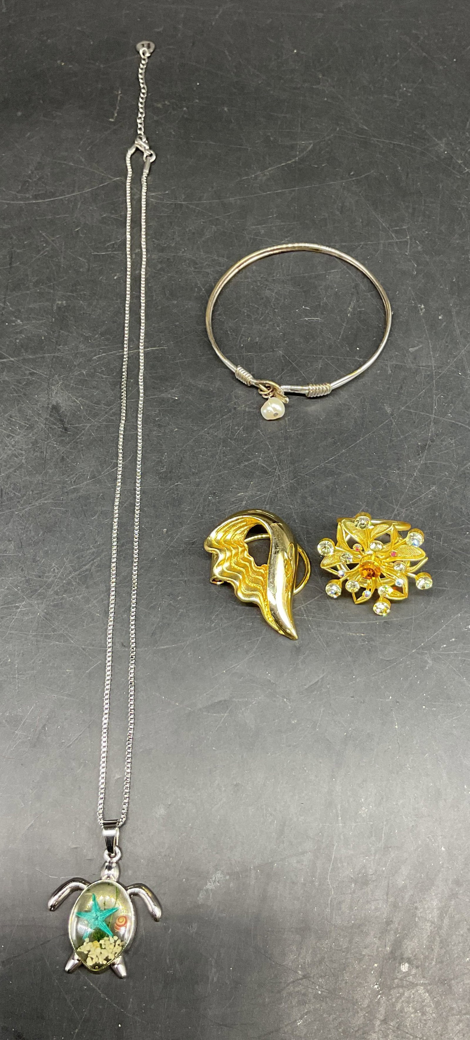 Lot 4 Vintage Assorted Jewelry Beachware NIB+: Lot of 4 vintage assorted jewelry. Beachware silver toned sea turtle pendant necklace, features an encased resin center with sand, shell, and starfish motifs, marked B, new in bag marked Deep In The O