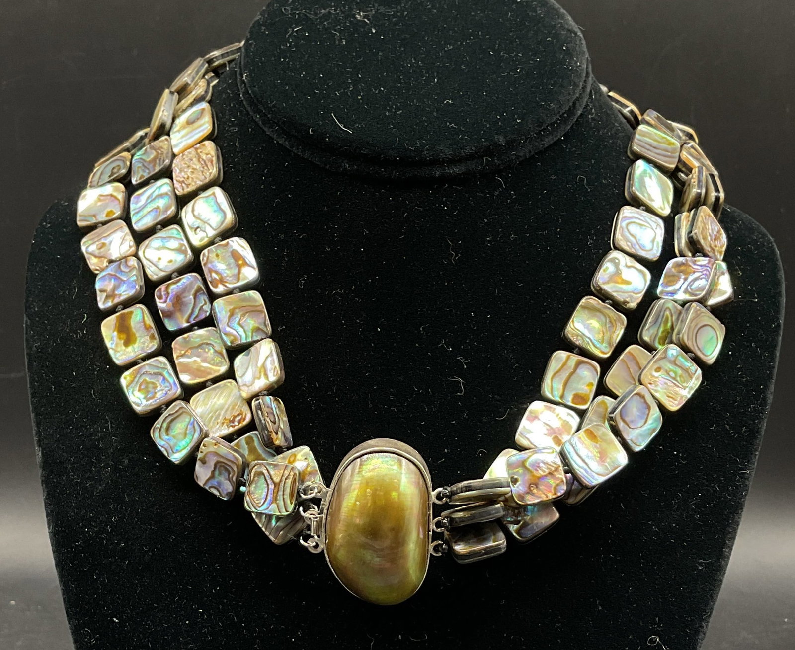 Vtg Sterling Silver Abalone Multi Strand Necklace: Vintage sterling silver abalone shell multi strand necklace. Central pendant is marked 925. Large abalone shell pendant, oval shaped. Iridescent abalone shell beads, greens blues pinks purples, square