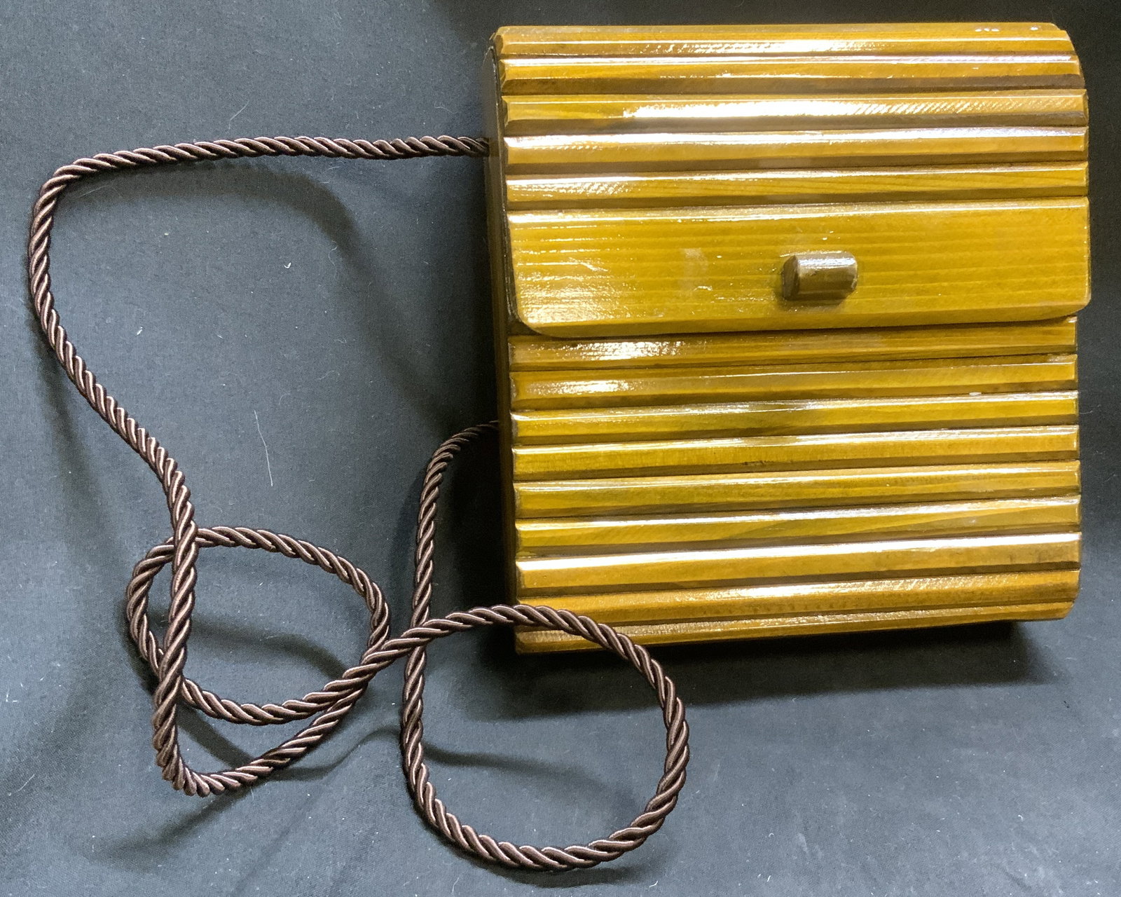 Vintage Boho-Style Wooden Panel Purse: Vintage Bohemian-Style Polished Wooden Panel Purse. Folding top flap. Natural wood grain visible. Braided rope strap. Velvet interior. Some scratching. Measures app 6.5in H x 6in L x 2.25in W. vintage