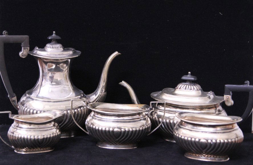 Sheffield English Silver Plate Coffee Tea Service: Silver plate with ebony wood handles. Coffee pot, teapot, sugar, creamer & waste bowl. Height of coffee pot 9 inches. Property of a Larchmont, NY estate.