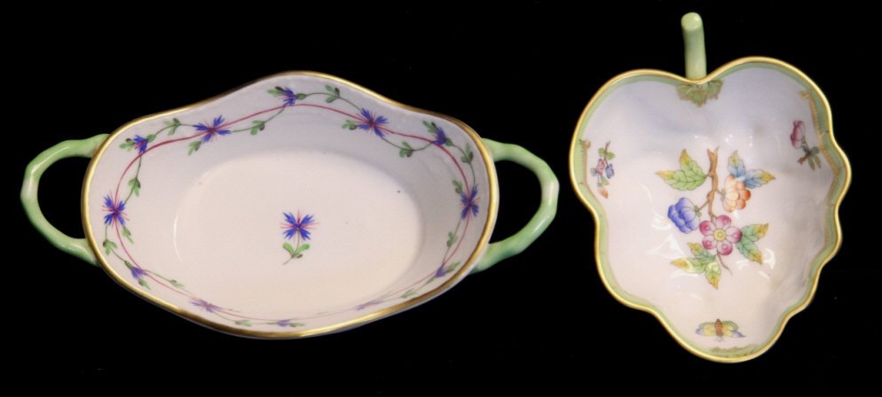 2 Hand Painted Herend Hungary Porcelain Dishes: One leaf form w. single handle, signed on bottom, butterflies & floral scenes. Second, w. 2 handles, exterior & interior scenes of blue flowers, signed on bottom. Width of larger 6.25 inches. Property