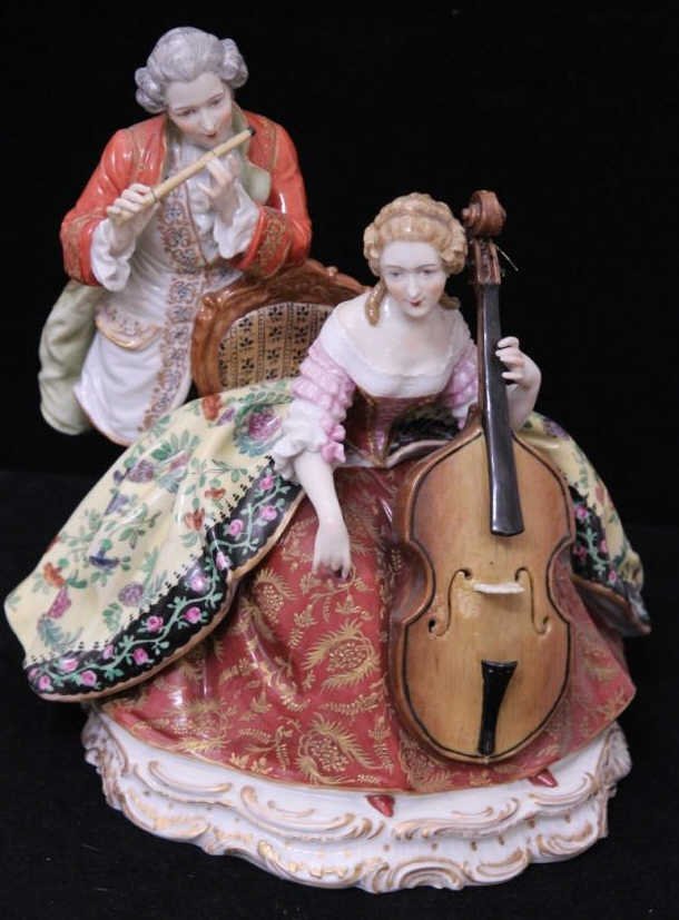 Antique Dresden German Porcelain Musicians Statue: Hand painted & gold enamel decorated porcelain statue showing a flute player & seated cellist. Blue hand painted mark on bottom. Height 10 inches. Width of base 9 inches. Property of a Larchmont, NY e