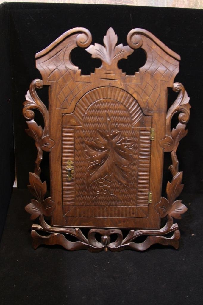 Antique Black Forrest Style Wall Cabinet: Hand carved door opens to single shelf interior. Height is 20 inches, width is 14.5, depth is 6 inches.
