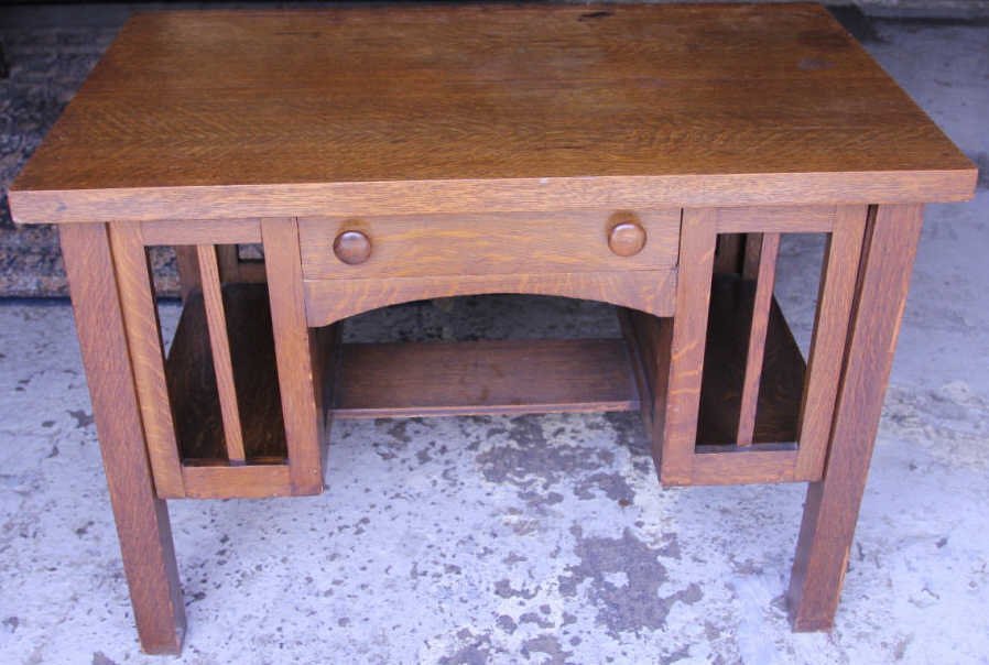 Antique Mission / Arts & Crafts Style Desk: Oak. Single drawer, open storage space at sides. Height 29 inches. Width 42 inches. Depth 26 inches.