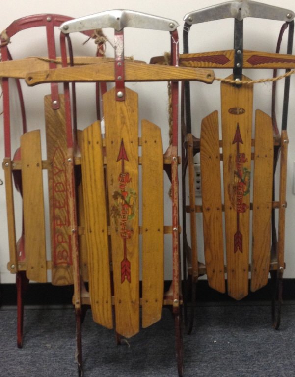 Three Vintage American Wooden Sleds: Great vintage items for interior decor or holiday display. Each with different graphics. Largest measures 42 inches in length.