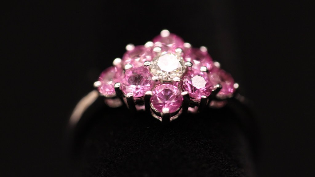 Contemporary White Gold & Diamond Flower Ring: Hallmarked for 18 kt gold. Approximately 2.7 grams inclusive.