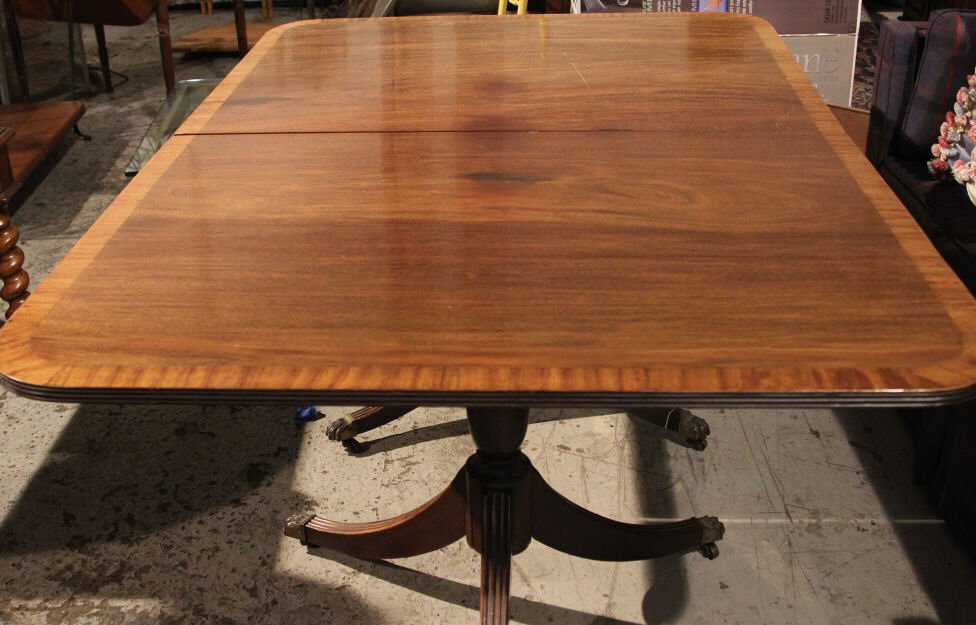 Antique Sheraton Double Pedestal Dining Table: Banded wood top & clawed feet. Two of three legs on one pedestal reattached. Height 29 inches. Width 64 inches. Depth 44 inches.