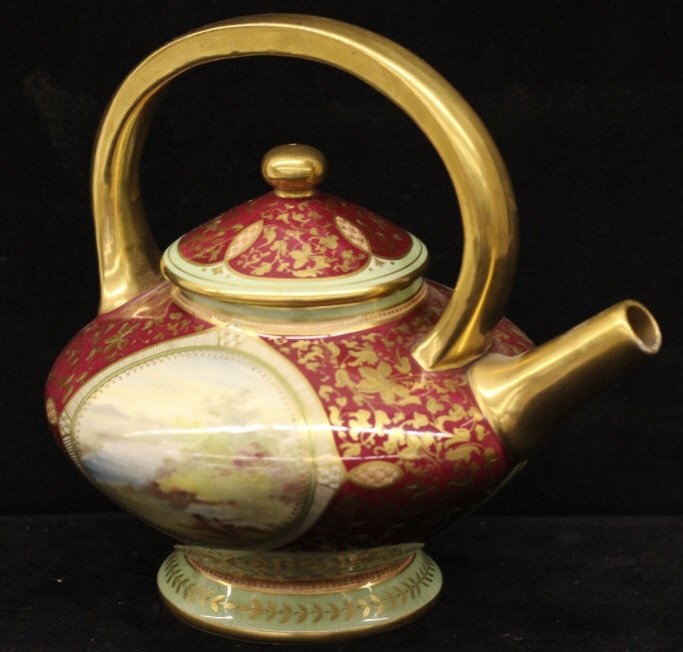 Antique Hand Painted Royal Bonn Portrait Teapot: Hand painted portrait at front. Landscape painting on back. All over gold enamel hand painted design against a green & burgundy background. Signed on bottom. Height 7 inches. Width 7 inches. Depth 6 i