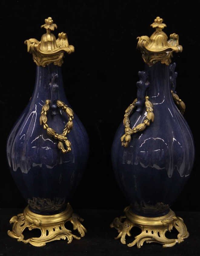 Pair Gilt Bronze Ormolu Chinese Vase Mounts: Antique pair Chinese style cobalt blue porcelain vases mounted in continental European style gilt bronze ormolu work. Likely French. Height 16 inches. Diameter 5.5 inches.