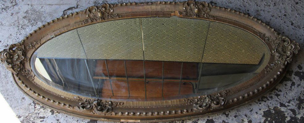 Antique Victorian Oval Gilt Mirror: Measures 58 inches by 28 inches.