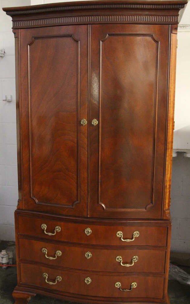 Contemporary Mahogany Armoire by Baker: Mahogany with satinwood tone inlay, bowed front, interior fitted with drawers. Height 78 inches. Width 39 inches. Depth 21 inches.