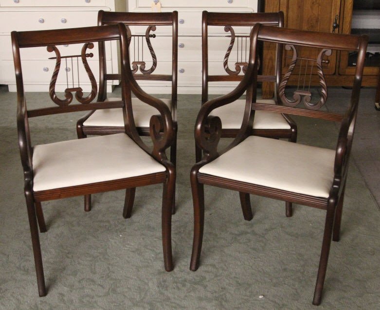 Set of 4 Vintage Mahogany Duncan Phyfe Chairs: 4 mahogany framed lyre back chairs. 2 side and 2 arm. Height 34 inches. Width 20 inches. Depth 18 inches.
