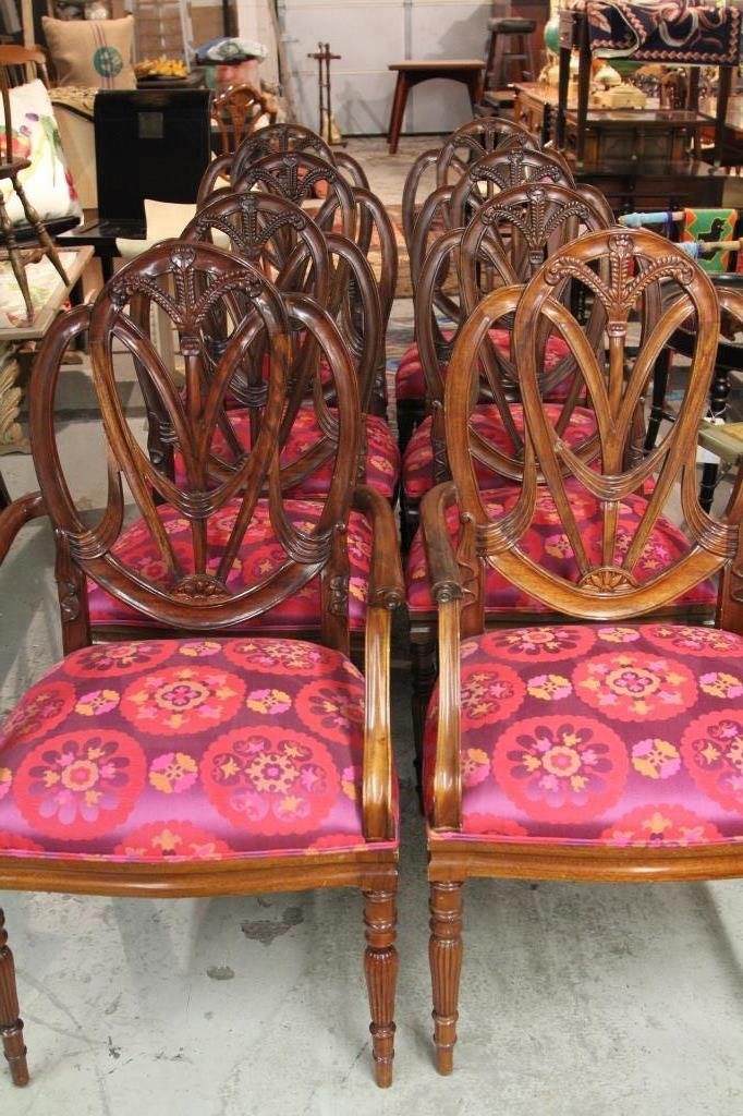 Set of 8 Sheraton Style Dining Chairs: Carved mahogany Sheraton style shield back, including two arm chairs and six side chairs. Silk upholstered seats. Height: 42 inches. Width: 22 inches. Depth: 21 inches