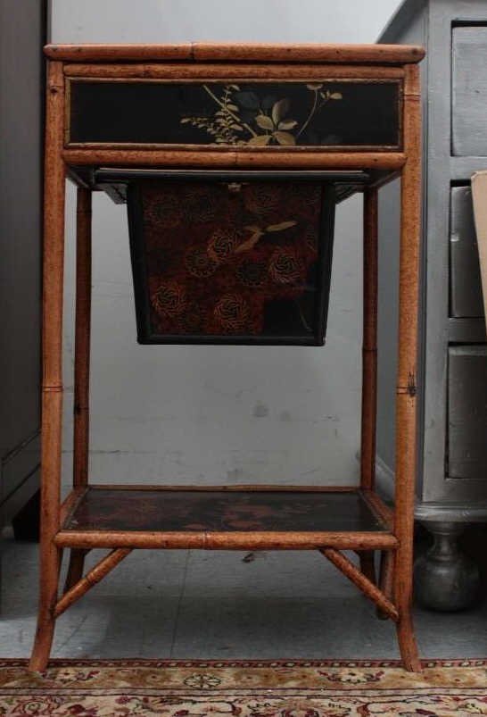 Antique Hand Painted Bamboo Sewing Table: Top opens to tufted silk lining. Under tray opens to silk tufted sewing basket. Hand painted, Chinoiserie scene. Height 28.5. Width 17 inches. Depth 12 inches.