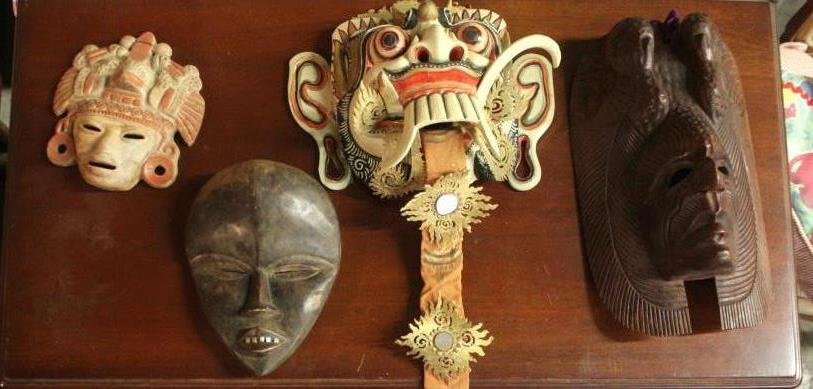 4 Assorted Tribal Masks: African, Mexican, Thai & Other wooden tribal mask. Largest measures 15 inches in length. 10.5 inches in width.