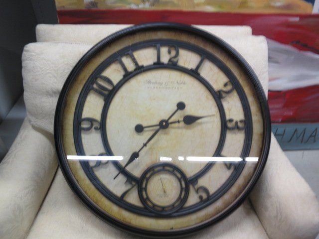Large decorative wall clock.: 29"Dia x 3 1/2"D. Battery operated.