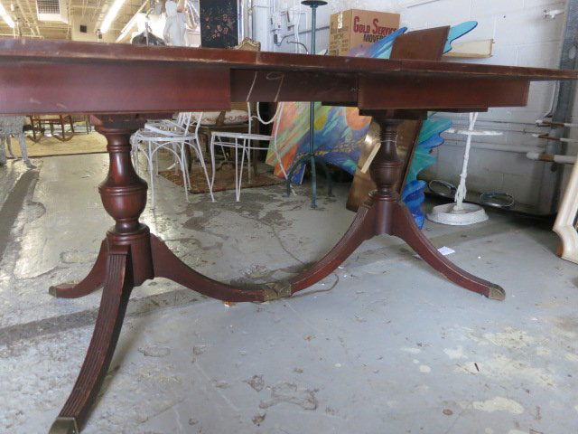 Regency Style Mahogany Double Pedestal DiningTable: A Regency Style Mahogany Double Pedestal Dining Table, 20th Century. Dimensions: h: 30 x w: 42 x d: 74 in. including one 12" leaf. Some surface scratches.