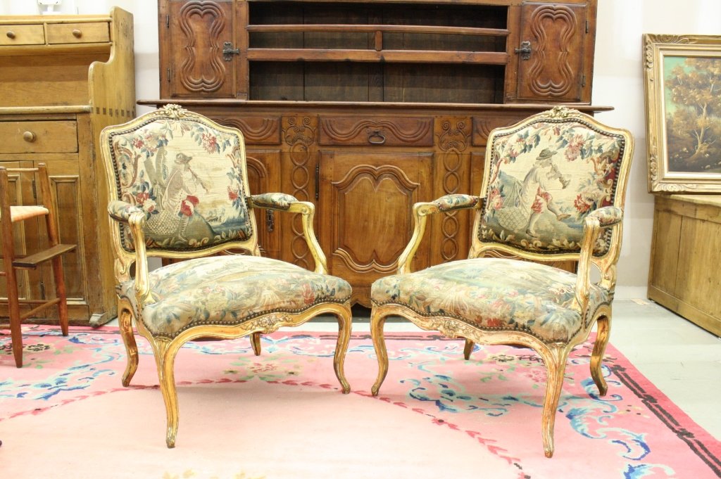 Signed Pair Antique Louis XV style Fauteuil chairs: Pair Antique Signed Louis XV Style French Rococo Gilt framed Open Bergeres, Fauteuils, Parlor chairs. Brightly gilded, ornately hand carved wood frame with colorful tapestry upholstered seats and Tape