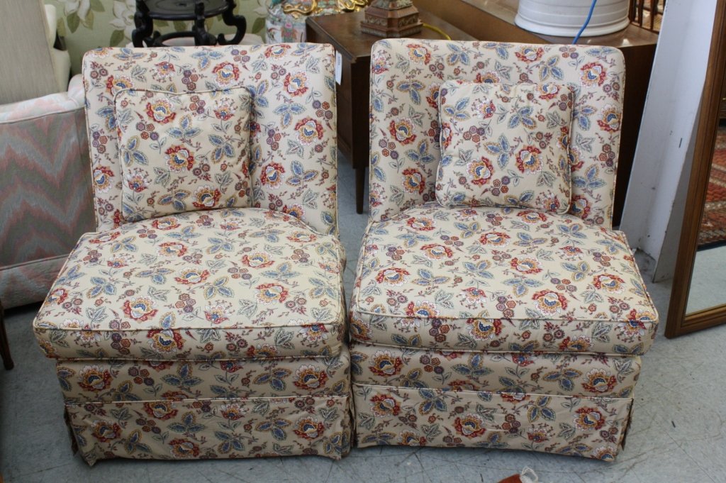 Pair of newly upholstered slipper chairs: Each has loose seat cushion and Barrel back with button tufting. Country French Provence style fabric in excellent condition. Trim silhouette. Each measures height 30 inches. Width 25 inches. Depth 22