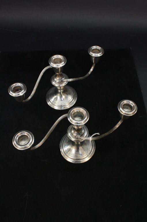 Pair of Gorham STERLING candelabras: Pair of three-candle double armed sterling silver candelabras each marked on bottom Gorham sterling name and trademark. Each measure 11 inches across.