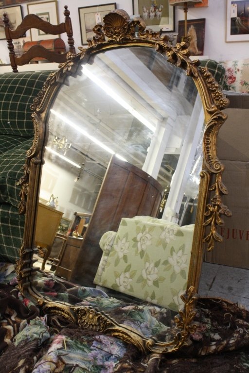 Antique Hand Carved Gold Leaf Empire Style Mirror: Antique European and Continental Carved vine & floral motif large mirror with scroll shells on top & bottom. Height 38 inches. Width 31 inches. Excellent Condition, wood intact.
