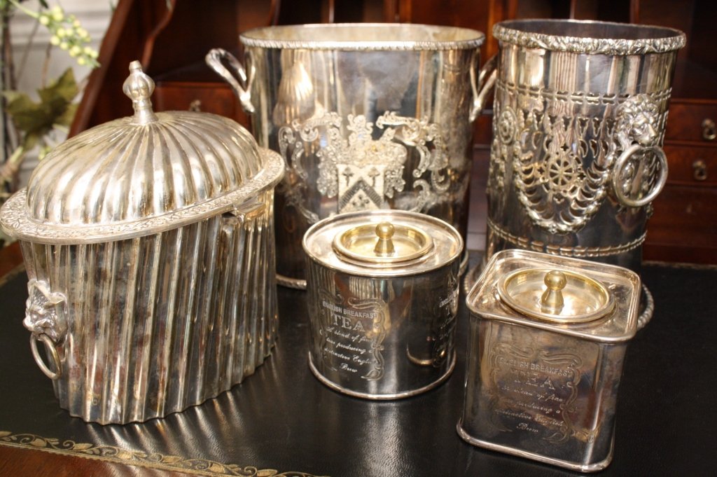 Silver plate Canister group lot: Group lot of Silver plate tea canisters, lidded container and wine coolers. Tallest measures seven inches. Very decorative. Marked for England on most pieces.