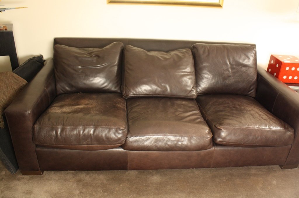 Black Leather Sofa loose seat and back cushions: Black leather sofa with loose seat and back cushions. Some wear to seat cushions. Measures length 82 inches, height 30 inches and depth 41 inches. . Property of a Bedford Estate.