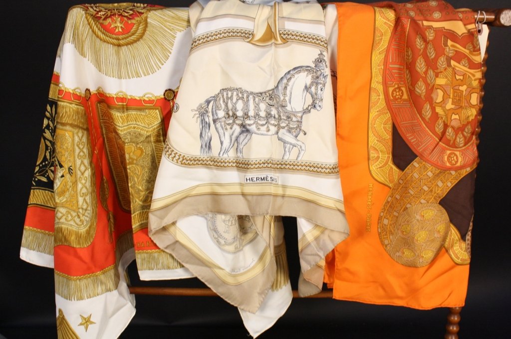 2 HERMES SCARVES & 1 SILK SCARF Vintage: From an Hermes Scarf collector. First titled Grand Apparat signed JACQUES EUDET, Hermes Ceremonial Horses in golds and creams, Second Tassels and Horse decor and plates, gold black red Titled Poste et