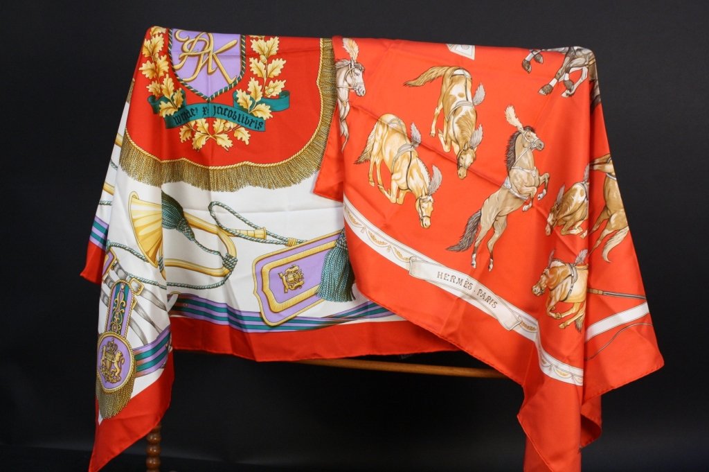 Two VIntage HERMES Scarves Cherry Red: Two Vintage Hermes Scarves signed for Hermes, First signed R.Daflet Titled En Piste features prancing Circus horses, Second features horns and emblems with broad red border. Each measures 36 inches sq
