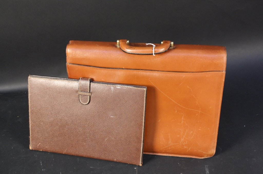 2 MARK CROSS Leather Items: First Mark Cross Signed Leather Brief Case with Brass Lock measures 16.5 wide by 12 inches high. Second Leather Folio Measures 13 inches length and height 9 inches. Art
