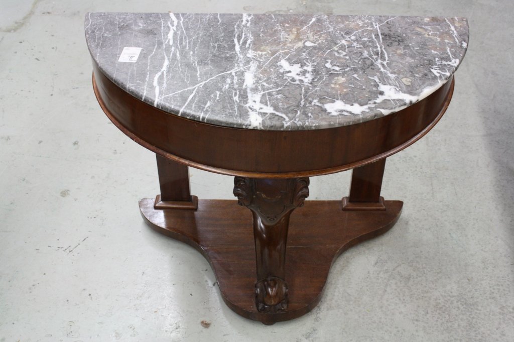 Mahogany Marble Top Fourier Table: Marble Topped Mahogany Base, ornately Carved Leg, Regency Style Semi Circle Table. Has one shelf. Measures 17 inches deep, 36 inches wide and 27 inches high.