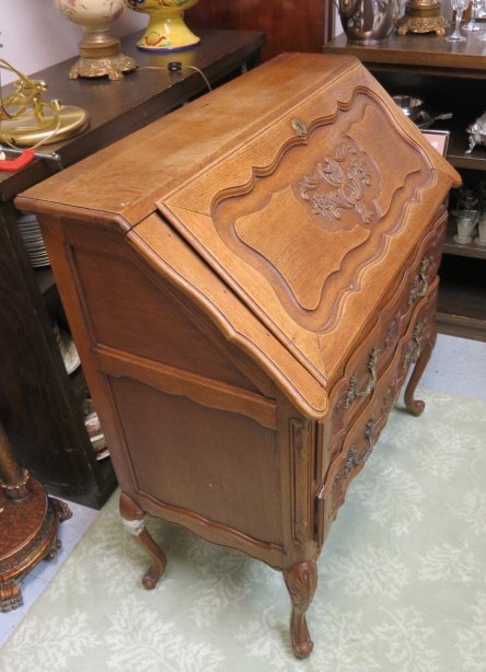 Belgium Oak Antique Secretary Desk: Antique chest secretary desk, Belgium oak. Carved drawer detailing and carved relief floral design and scroll work. Carved drawer fronts and legs. One leg re-glued and repaired. Measures 39 inches hig