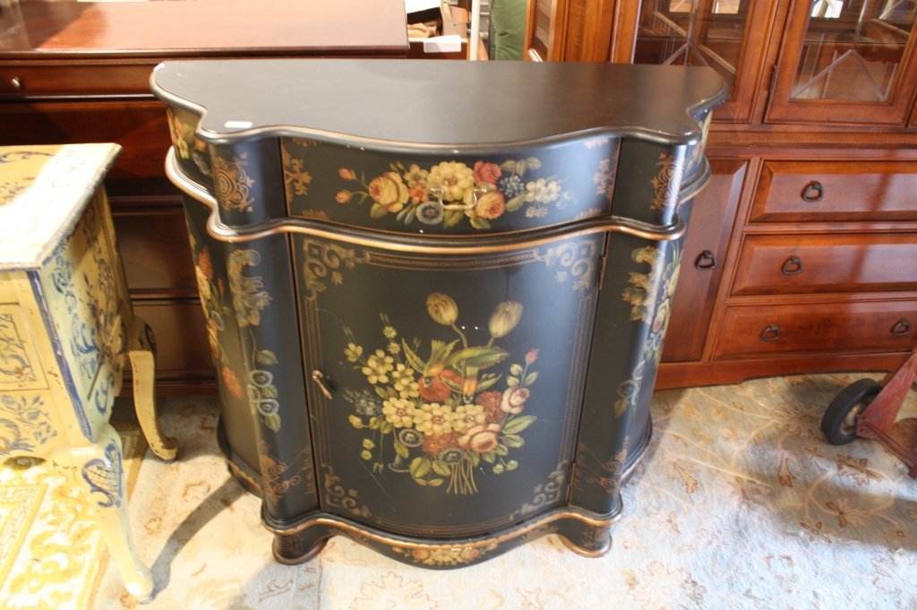 20th C Painted Black Chest Serpentine: 20 th Century hand painted on black background serpentine front chest on short feet.floral design with gold trim accents. Decorative. Measaures 39.5 inches by 44 inches by 18 inches.