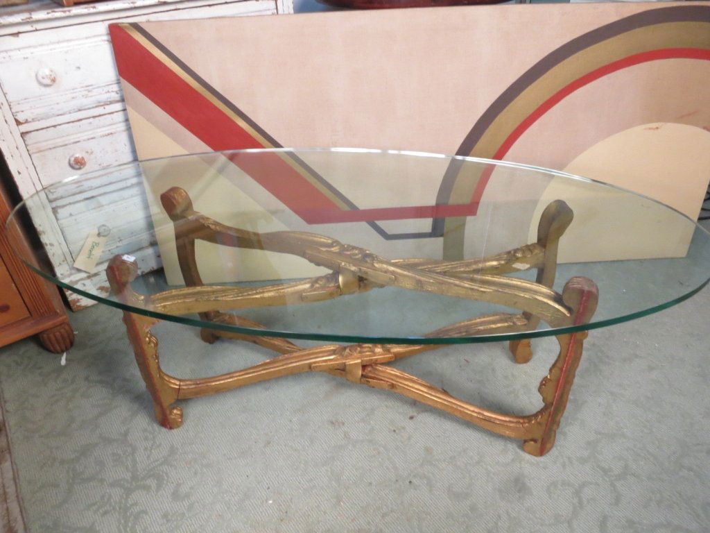 C. 1940's Carved Wood and Glass Coffee table: Oval Glass topped coffee table cocktail table on carved gilded wood base. made in Italy Bellieve Circa 1940's. Measures Length Width Height.