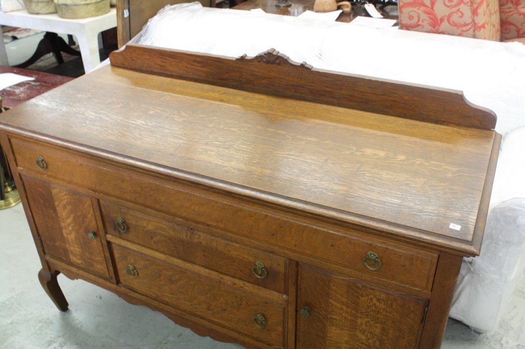 Traditional Vintage Hardwood Sideboard: Traditional Hardwood Sideboard with brass hardware. Splayed Bracket Feet. One wide drawer over 2 drawers and 2 cabinets. Measures 54 inches wide by 22 inches deep by 37 inches high.