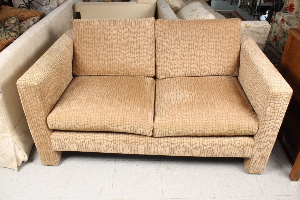 Cream Upholstered Settee: Upholstered Settee in Cream and Coffee upholstered fabric. Measures 57 inches wide by 35 inches deep by 75 inches high